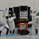 Planet staff Michael Soulage, Natasha Nogueira, Raul Antonio Perez prepare a SkySat for launch.